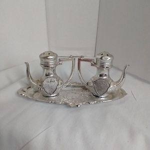 Pair of souvenir salt and peppers on tray